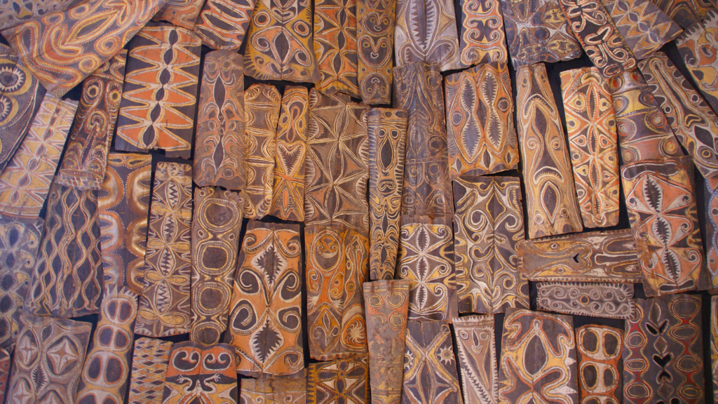Collection of Papua new guinea wood carvings in many different kinds of patterns.
